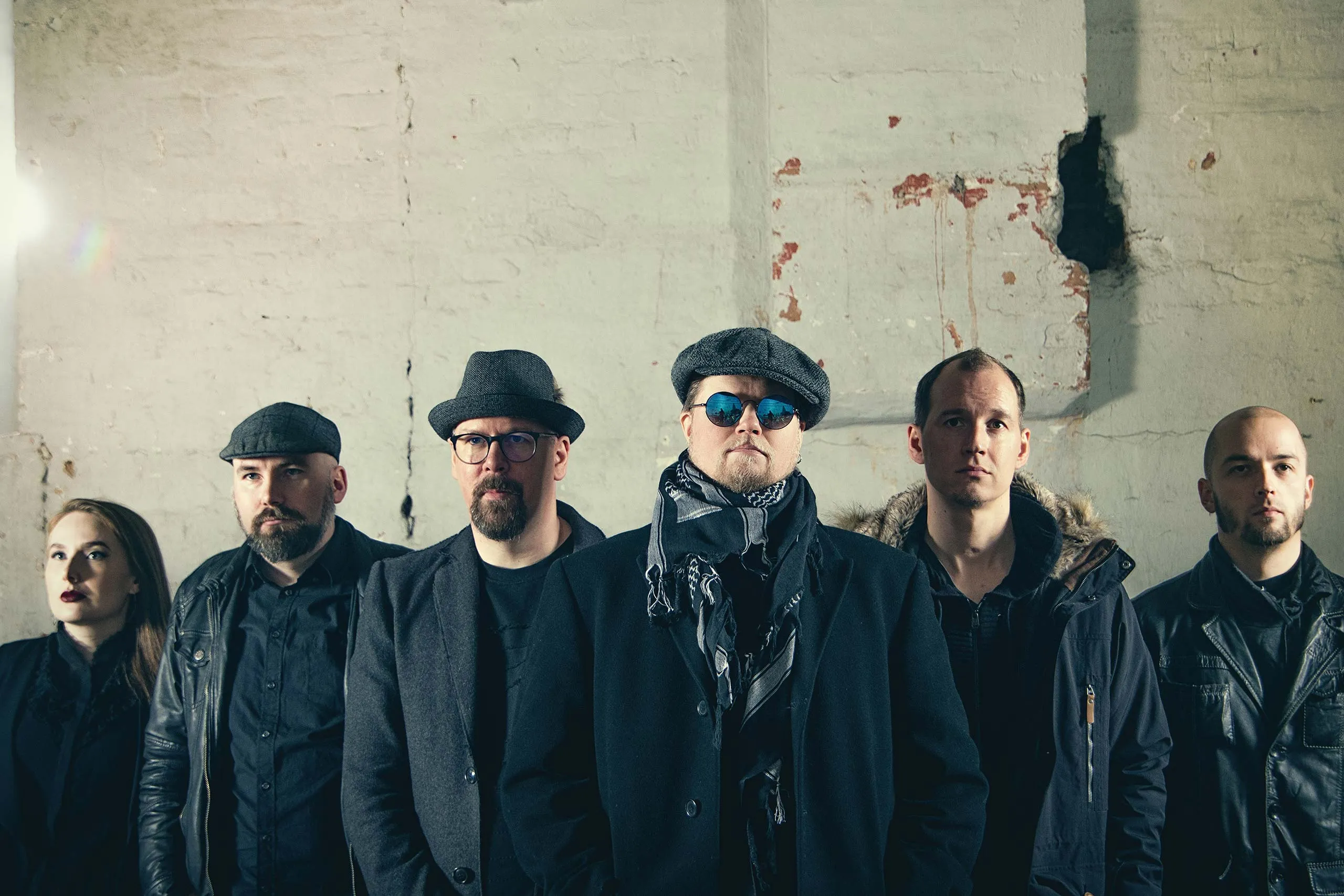 The six members of Fragile Dream in front of a white plaster wall